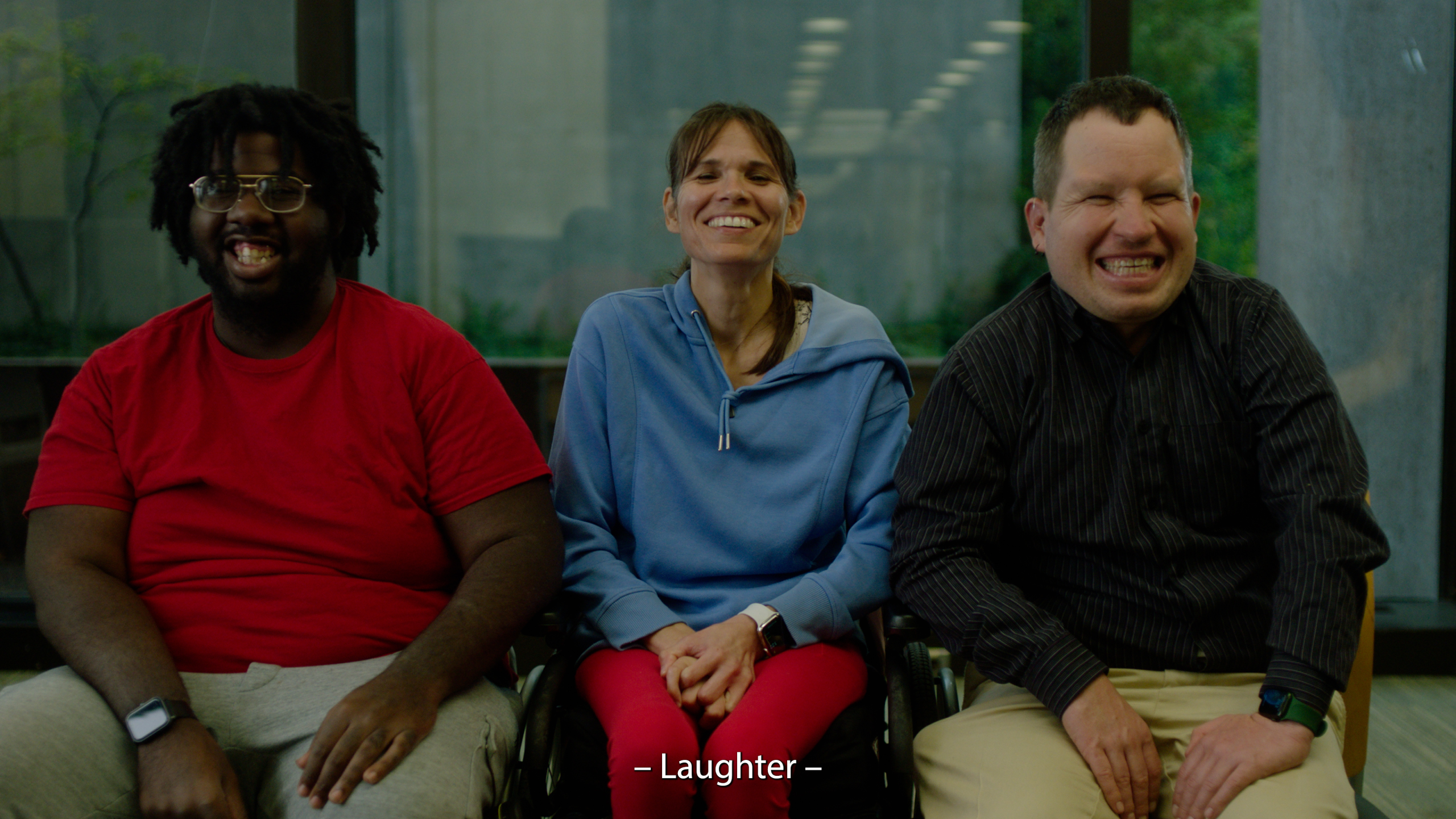 Three actors with intellectual disability laugh during the filming of the Engage Toolkit's welcome video